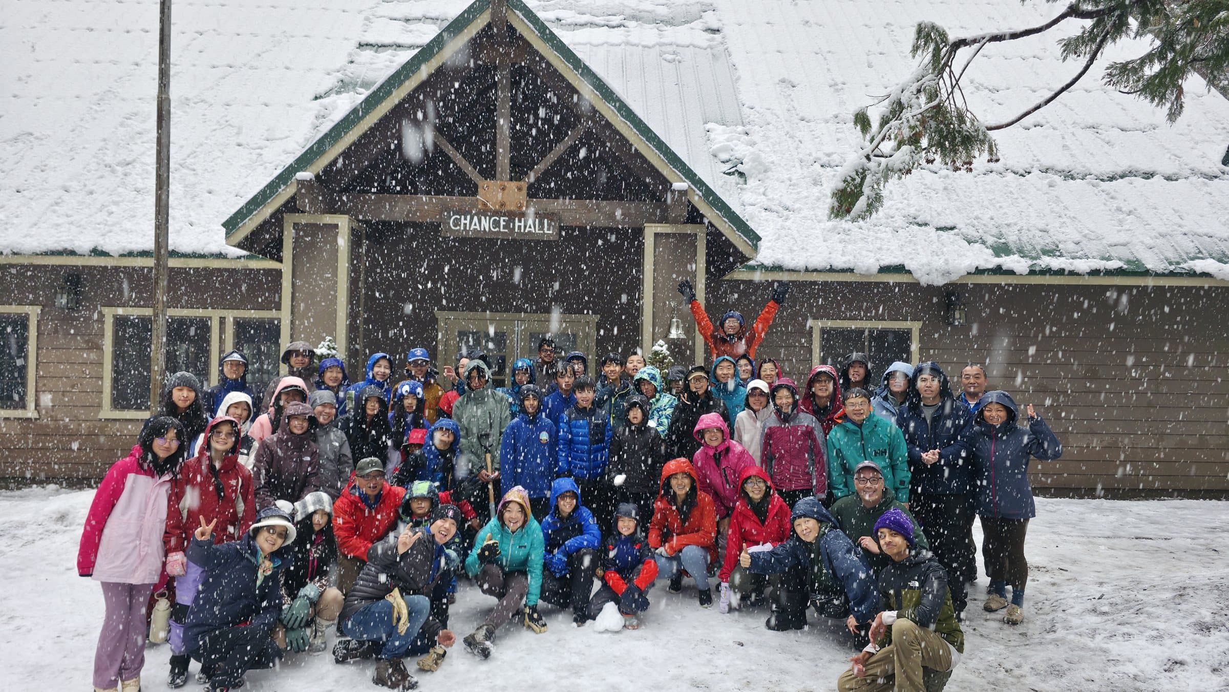 Troop group photo in front of the snow camp lodge during winter camp